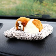 A toy on a car panel, a dog on a pillow, a white-red color