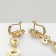 Hanging earrings with “evening” rhinestones, white-red color in gold, 7 cm