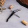 Wine set: a soda knife with a corkscrew, a drip, a foil knife and a plug for wine with chess "Golden Man".
