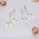 Earrings hanging "rustle" crosses, color mix, 8.5 cm