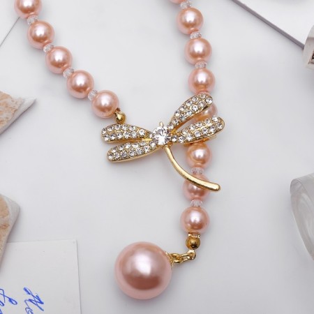 The necklace is “pearl” with a flipping element, dragonfly, pink color in gold, 50 cm-1