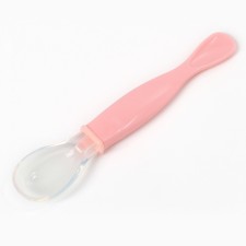 A spoon of children's silicone for feeding, pink color