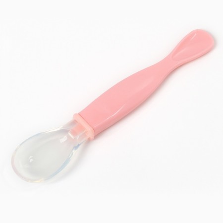 A spoon of children's silicone for feeding, pink color