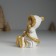 Souvenir Polystone "Baby in a white fur coat, with a heart" sits 5x5x8 cm