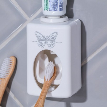Mechanical “butterfly” toothpaste dispenser, 9.5 x 5.8 cm.