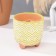 A candle made of soy wax in the kashpo "Patterns with legs", 9x8.5 cm, mix