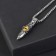 Pompeii pendulum of a dagger with an eye, yellow color in black silver, 70 cm