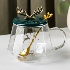 Glass mug with a ceramic lid and a spoon 