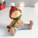 Polystone souvenir "Baby in a red hat and green scarf sits" 12.5x12x12.5 cm