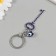 Keychain from the evil eye Metal "key with pebbles" 2.4x6.5 cm
