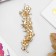 Brooch "Freech with flowers", white color in gold