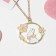 Children's pendant "chosen" bunny, white-pink color in gold