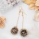 Earrings hanging “wandered ball”, black color in gold, 6.5 cm