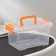 The storage container is plastic, 20 × 15 × 11 cm, a cover with a handle on a latch, matte