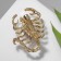 Brooch "Scorpio" drop, black and blue color in gold