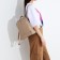 A backpack with a zipper, 2 outer pockets, beige color