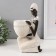 Souvenir Polystone stand "African sits, with a wicker pot" White 14x9x24 cm