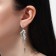 Hanging earrings with rhinestones "Circus" ice floes, white color in silver, 7 cm