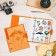 A notebook on rings A5 120 sheets in the Lorex "Neon. Orange" cage, with a change of block, a plastic cover, with stickers