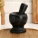 A mortar with a pestle made of stone is medium, 250 ml, black marble, in a box