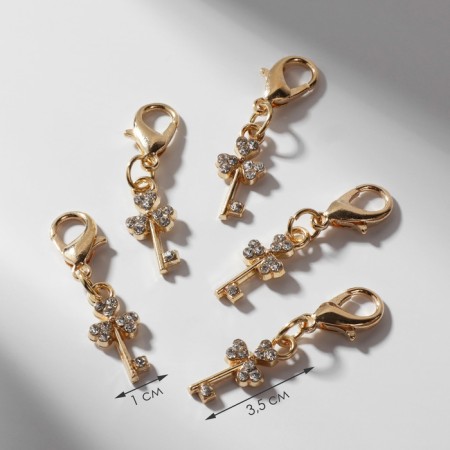 Charm "Key", white color in gold