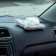 Toy on a car panel, a cat on a pillow, white color