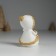 Souvenir Polystone "Baby in a white fur coat, with a heart" sits 5x5x8 cm