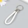 Keychain metal to the leatherette "strap" white 10x4 cm