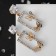 Earrings with rhinestones "flutter" butterflies in a rectangle, white color in gold