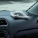 Toy on a car panel, a dog on a pillow, gray color