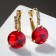Earrings with Crystal rhinestones are bright, white-red color in gold