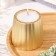 A candle in a candlestick of gypsum with smooth faces, 9.5x9cm, gold