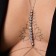 Erotic accessory on the chest, with rhinestones, golden