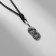 Curriculor's pendant "Uroboros", color black silver on a black lace, 43.5 cm