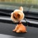 Dog on a car panel shocking his head, a mongrel