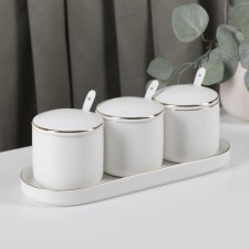 A set of ceramic cans with spoons on the stand 