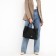 The bag is female, medium size, long belt, black color