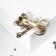 Brooch "Kit" with a bow, the color is emerald white in gold
