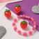 Set of children's "chosen" 3 subjects: clips, bracelet, ring, strawberries, colored