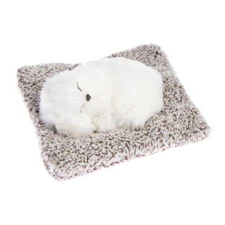 Toy on a car panel, a dog on a pillow, white color