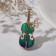 Brooch "Violin" with a butterfly, the color is blue-green in gold