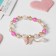 Bracelet Children's "chosen" butterfly, lilac-pink color in gold