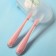 A set of silicone spoons for feeding, 2 pcs., In a container, pink color