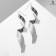 Earrings with rhinestones "Wave" spiral, white color in silver