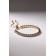 Bracelet with rhinestones "shine" on a puff, the color is white in gold