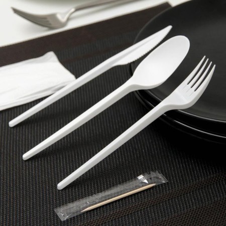 A set of plastic disposable cutlery 5 in 1: fork, spoon, knife, napkin, toothpick, white color