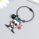 Acryl keychain on a cable with a bell "Bearded guy with glasses and rose"