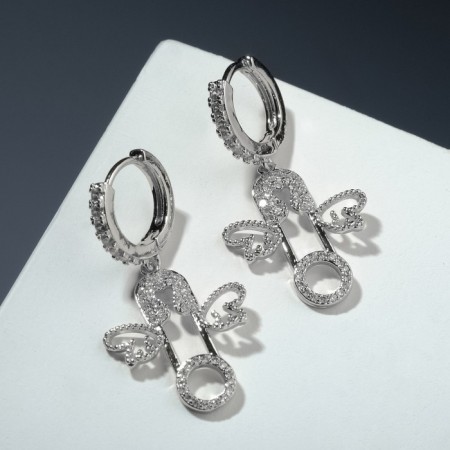 Earrings with rhinestones "pin" with wings, white color in silver
