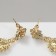 Earrings with “openwork” rhinestones duet, emerald color in gold
