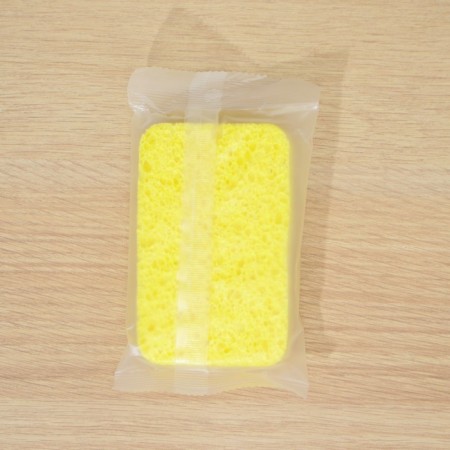 A dispenser for a detergent with a stand for the Raccoon sponge, a sponge included-6
